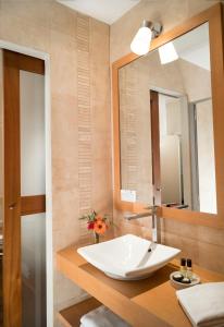 a bathroom with two sinks and a mirror at Grand Hôtel Les Lecques in Saint-Cyr-sur-Mer