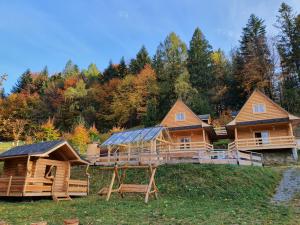 a log cabin in the woods with a house at Cicha Polana in Szczyrk