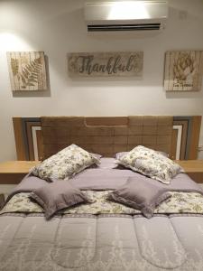 a bed with two pillows on top of it at Purple Lily Studio Hawana Lagoons Salalah in Salalah +48 photos