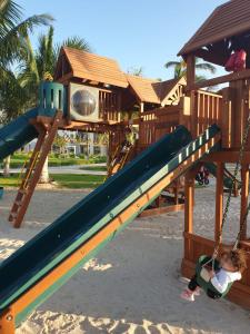 a child playing on a slide at a playground at Purple Lily Studio Hawana Lagoons Salalah in Salalah