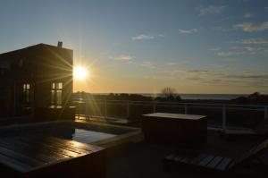 a sunset on the roof of a house at Hotel Bahamas in Montevideo