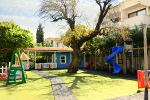 a playground with a tree and a slide at Club Anastasia - Family Hotel in Marmaris