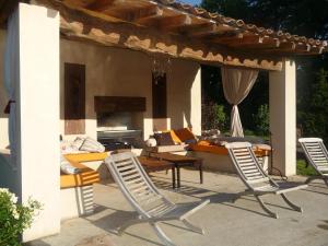 a patio with chairs and a table and a couch at Chambres d'hôtes La Masquière in Villefranche-de-Lauragais