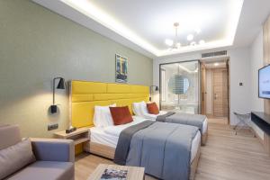 A bed or beds in a room at ROX Hotel Ankara