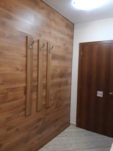 a wooden wall in a room with a door at Private Rooms Silvia in Varna City