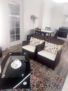 a living room with couches and a table at Rozinka apartman in Dunaújváros