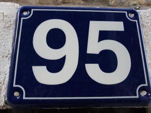 a blue and white sign with the number at Apartments Teodora Obala in Petrovac na Moru