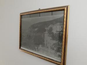 a framed picture of a painting on a wall at Apartments Teodora Obala in Petrovac na Moru