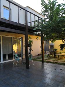 a patio with chairs and a table and a building at Duplex a pasitos del centro contactar número primer foto in Posadas