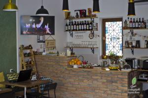 a bar in a restaurant with a brick wall at Hotel Lopota Gate in Napareuli