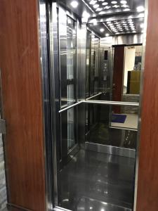 a glass elevator in a room with a door at Hotel Hormiga Real in Valle del Guamuez +15 photos