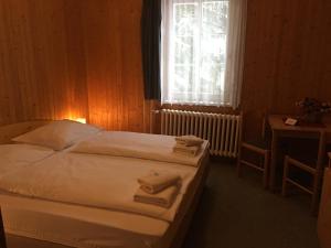 Postel nebo postele na pokoji v ubytování Hotel Tři Růže