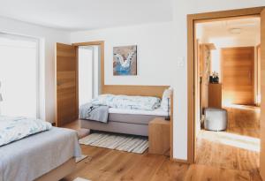 a bedroom with a bed and a mirror at Haus Harmony Apartments in Ramsau am Dachstein