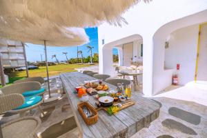 a table with food and an umbrella on a patio at Kenting South Border DeSign Hotel in Eluan