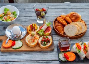 a table with sandwiches and bread and a bowl of food at Kenting South Border DeSign Hotel in Eluan