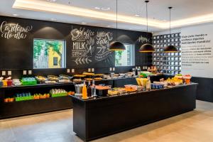 a counter with a variety of food items on it at ibis Styles SP Centro in Sao Paulo