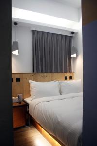 Postel nebo postele na pokoji v ubytování Just Inn Xin Yi 正旅館 信義