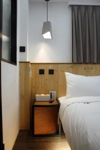 Postel nebo postele na pokoji v ubytování Just Inn Xin Yi 正旅館 信義