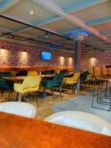 a waiting room with chairs and tables and a tv at Hostel The Globe in Amsterdam