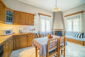 a kitchen with a table and chairs in a kitchen at Family House with Garden in Igoumenitsa
