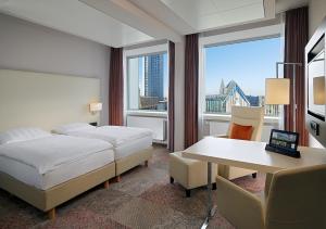 Postel nebo postele na pokoji v ubytování Radisson Blu Hotel Leipzig + 37 fotografií