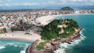 an island in the ocean next to a beach at Stela Maris in Guaratuba