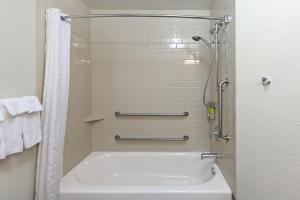 a bathroom with a shower and a bath tub at Candlewood Suites Houston - Spring, an IHG Hotel in Houston