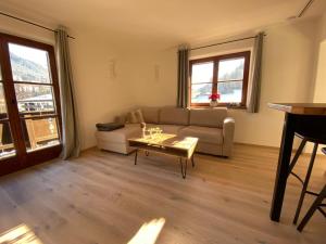 a living room with a couch and a table at Haus Ingrid in Kitzbühel