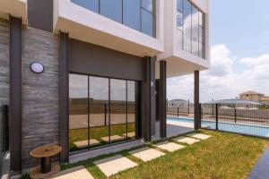 a rendering of a house with a swimming pool at Alimama Spaces: The Manson's 8 On New in Midrand
