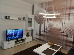 a living room with a flat screen tv on a wall at Apartament -Sweet Home in Lubin