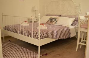 a bedroom with a white bed with a woman on it at IL MORO holiday home in Siracusa