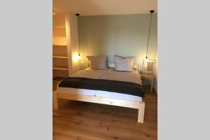 a bedroom with a bed with a hanging bed frame at Apartment - SÜDWÄRTS - im Blauen Land in Murnau am Staffelsee