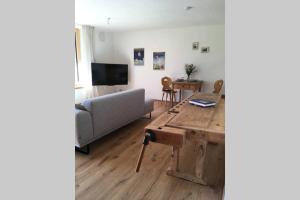 a living room with a couch and a table at Apartment - SÜDWÄRTS - im Blauen Land in Murnau am Staffelsee