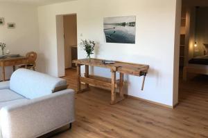 a living room with a table and a couch at Apartment - SÜDWÄRTS - im Blauen Land in Murnau am Staffelsee