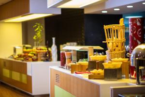 a bakery with a counter with food on it at Holiday Inn AlSeeb Muscat, an IHG Hotel in Muscat