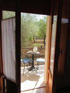 an open door to a patio with a table and chairs at Villa Il Giovane Alloro in Martina Franca