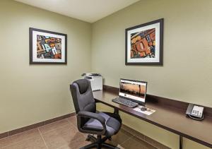 a office with a desk with a computer and a chair at Candlewood Suites Houston - Spring, an IHG Hotel in Houston