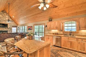 a kitchen with wooden cabinets and a ceiling fan at Mountain-View Franklin Retreat: Near Hiking! in Franklin