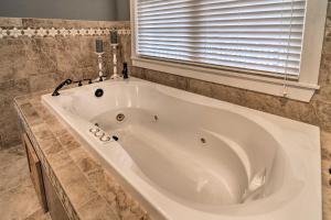 a large white tub in a bathroom with a window at Mountain-View Franklin Retreat: Near Hiking! in Franklin +19 photos