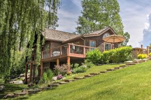 a log house with a deck and a lawn at Rivers Edge Mtn Home Private Hot Tub and Views in Glenwood Springs