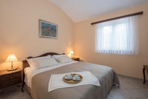 A bed or beds in a room at Apartments Viler