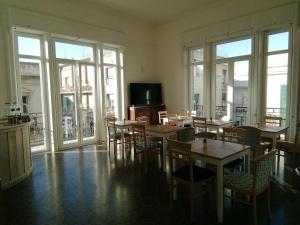 a dining room with tables and chairs and windows at Ace Rooms VSG in Villa San Giovanni