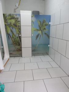 a bathroom with a mural of a palm tree at Residencial Coração do Mar in Palhoça +51 photos