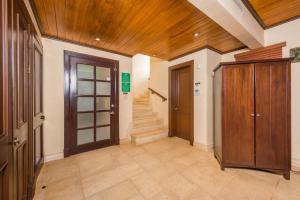 a hallway with wooden ceilings and stairs in a house at Jet Luxury at Langosta Beach Resort & Villas in Tamarindo
