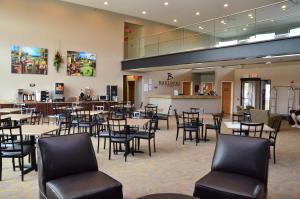 a dining room with tables and chairs in it at Qube Hotel - Polk City in Polk City