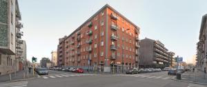 a large red brick building on a city street at CASAJULIENNE in Milan