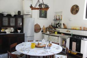 a kitchen with a table and a refrigerator at Villa Anita in Levanto