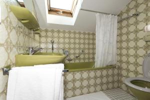 a bathroom with a sink and a toilet with towels at BergLiebe in Unterammergau +31 photos