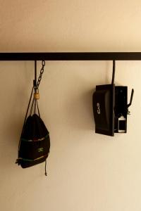 a purse and a camera hanging on a wall at Downtown Beds in Mexico City