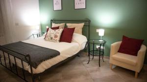 a bedroom with a bed and a chair at Alice in Wonderland in Naples